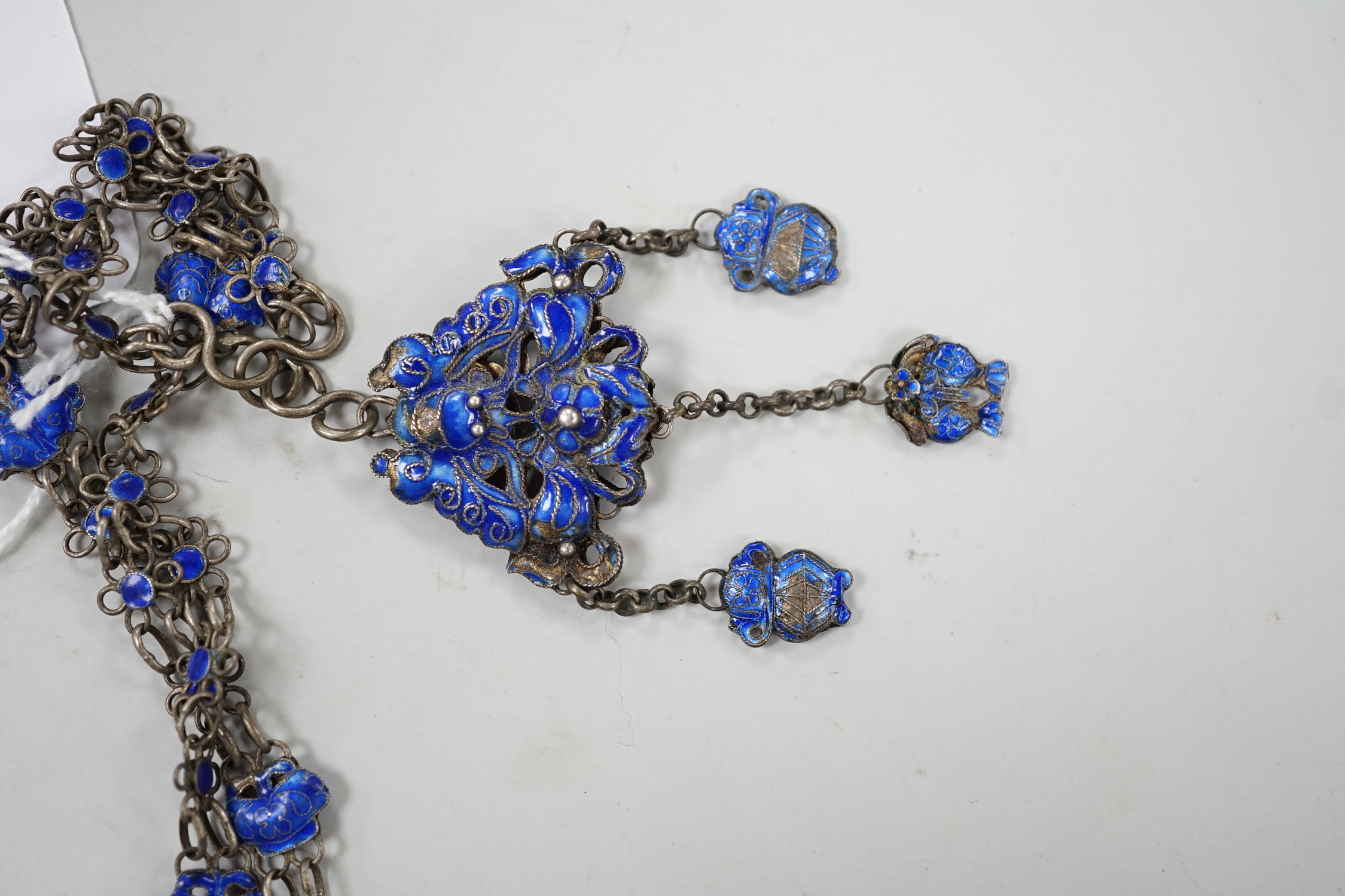 A long Chinese white metal and blue enamel set drop necklace, 204cm.